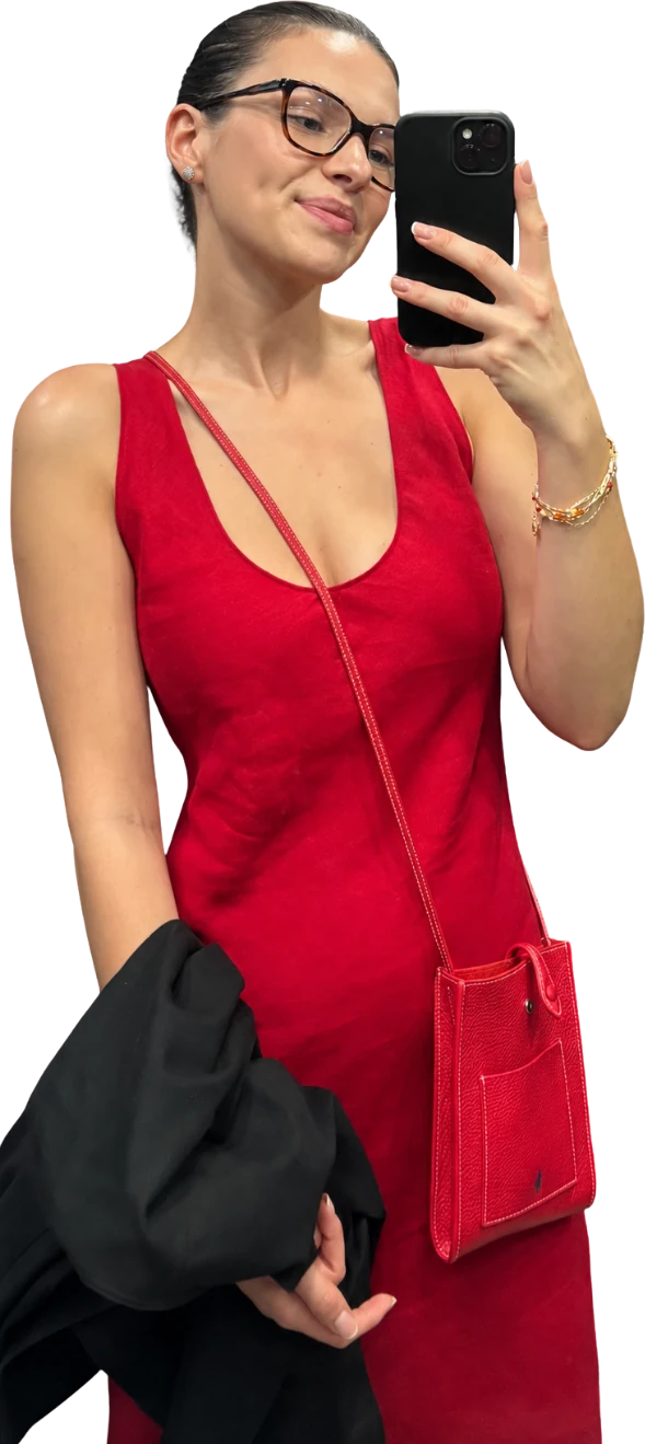 Ola in a red dress, taking a mirror selfie